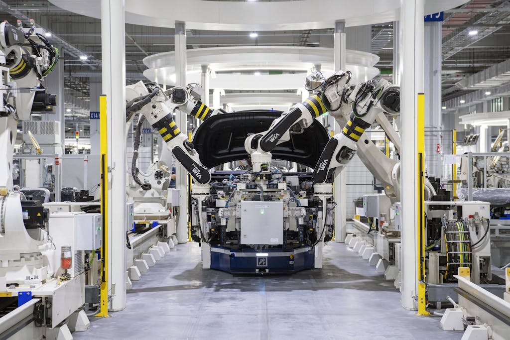 Robots assembling a car in a modern factory