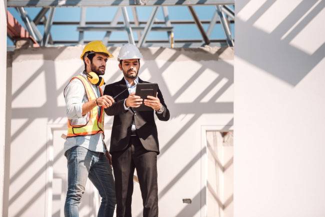 2024 Trends in Construction Project Management 7 civil engineer construction worker manager holding digital tablet blueprints talking planing about construction site cooperation teamwork concept 1 650x434 1