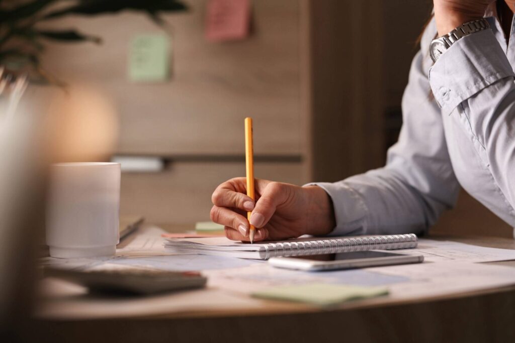 Project Management Tools: From Pen & Paper to Modern Software 6 unrecognizable businesswoman working office writing business plans her notebook 2 scaled 1