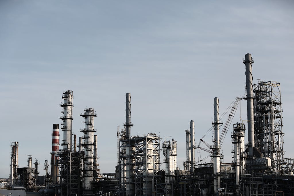 Industries 5 Skyline view of an industrial factory with tall chimneys against a clear sky.